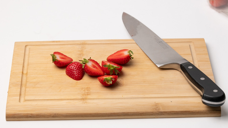 sliced strawberries on chopping board