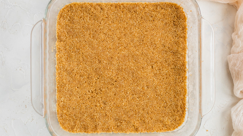 graham cracker crust in a square pan