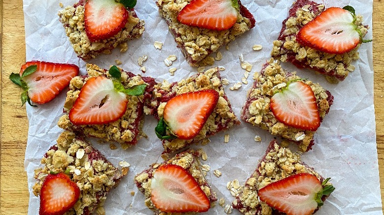 oat bars with sliced strawberries on board