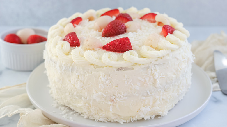 Strawberry, coconut, and lychee layer cake on a plate