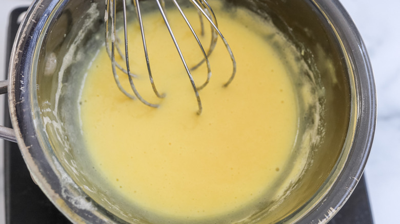 Eggs, sugar and coconut milk being heated in a double boiler