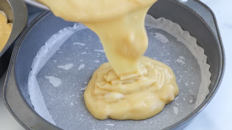 Batter being poured into cake pans