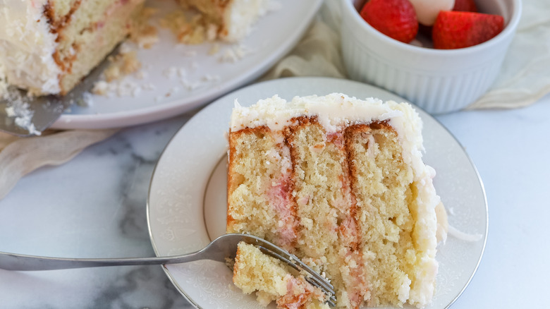 Close up of a slice of strawberry, coconut, and lychee layer cake