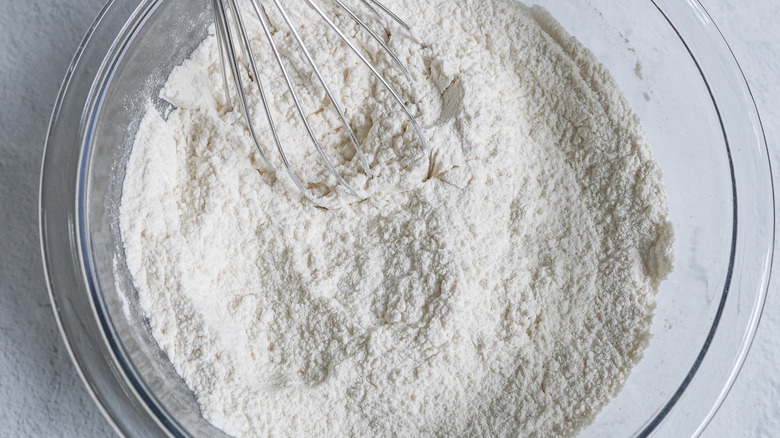 whisking flour mixture in bowl