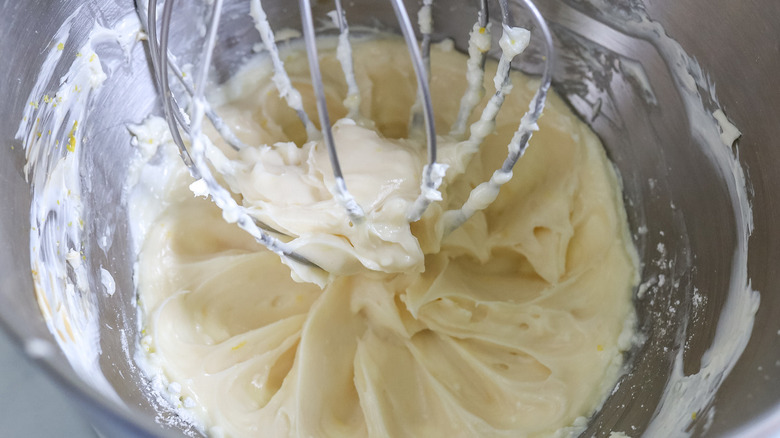 white frosting in mixing bowl