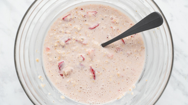 combining strawberry overnight oats ingredients