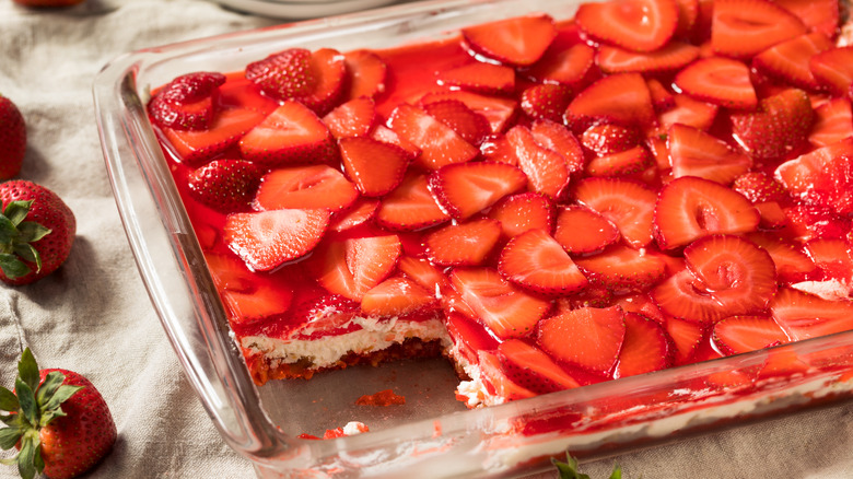 Pan of strawberry pretzel salad with piece removed