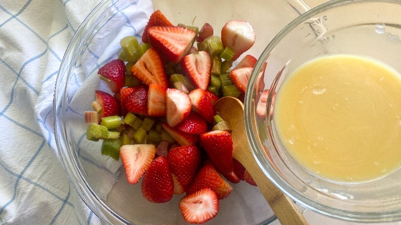 strawberries and rhubarb in glass bowl