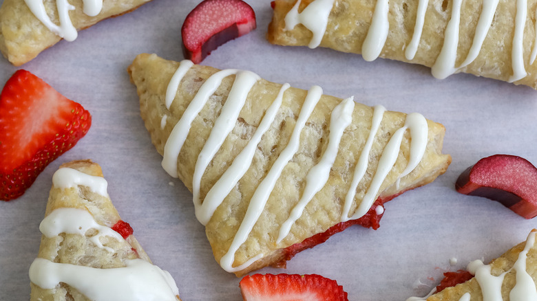 turnovers with strawberry and rhubarb pieces around them