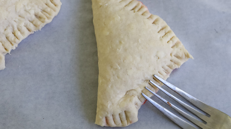 a fork crimping the edges of a turnover