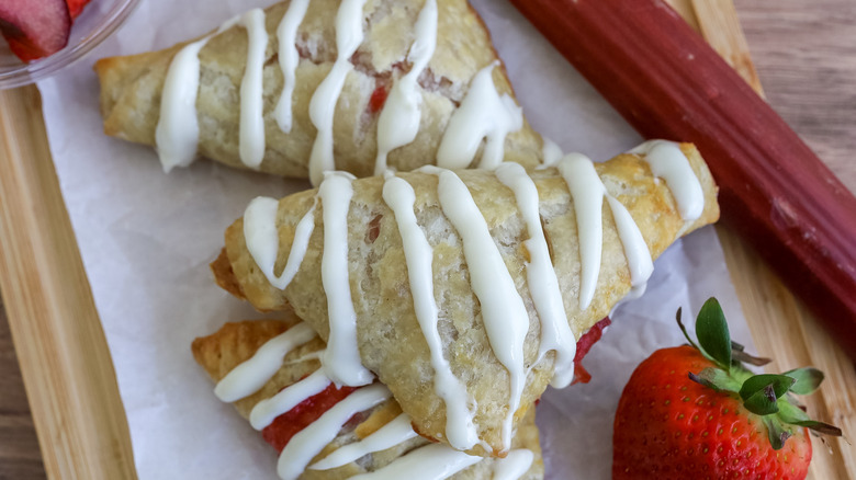 baked strawberry rhubarb turnovers on a cutting board