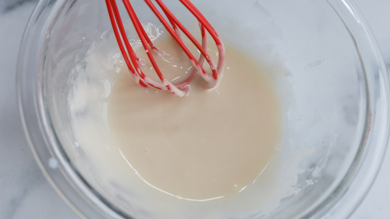 whisking icing in bowl