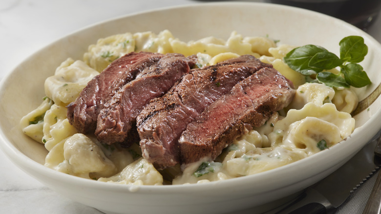 pasta with steak in bowl