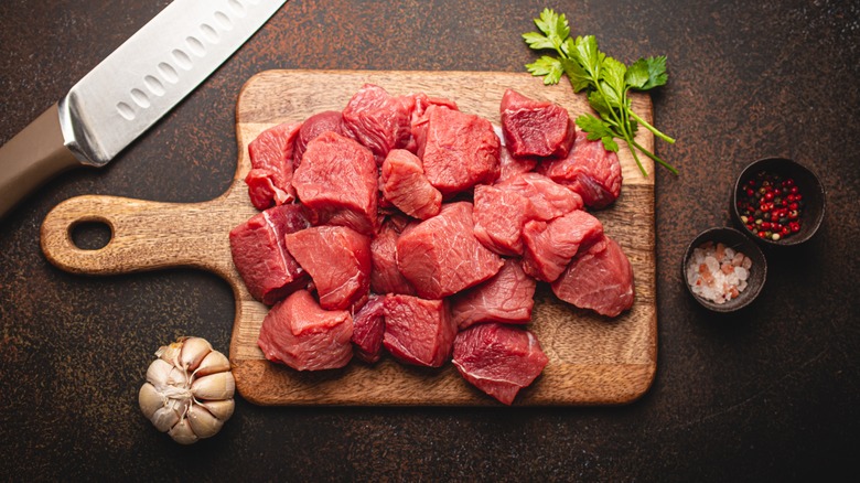 raw steak cubes on board