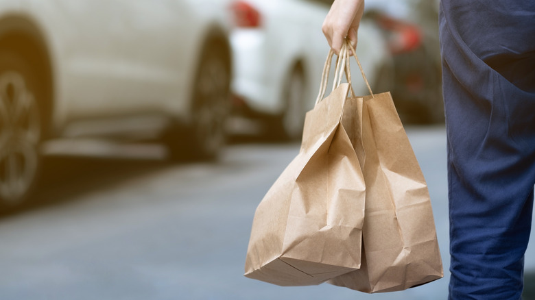 person carrying bags of food