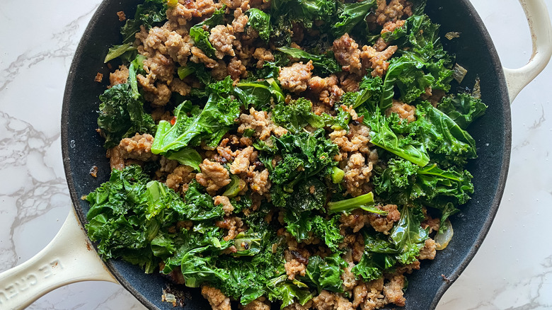 kale, sausage cooked in skillet