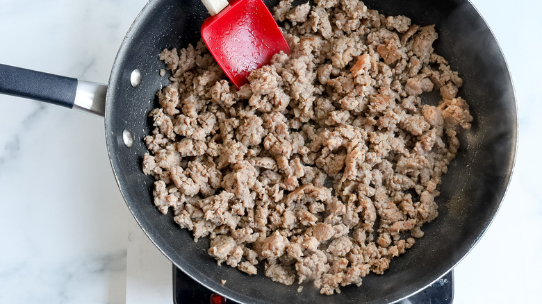 crumbled sausage cooking in pan