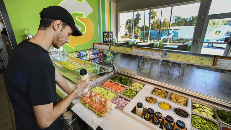 Subway employee makes sandwich