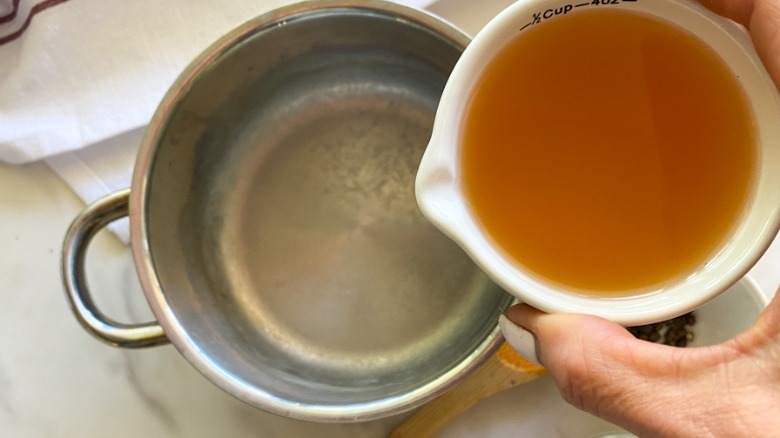 vinegar pouring into small pot