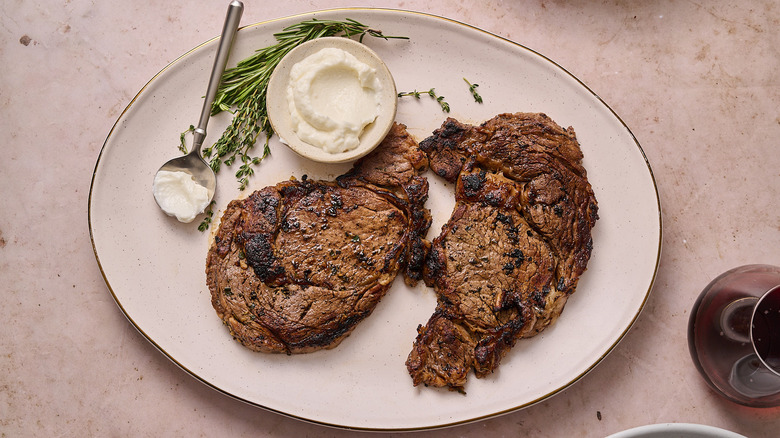 marinated delmonico steaks on plate