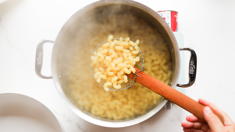 Pasta being removed from water pot