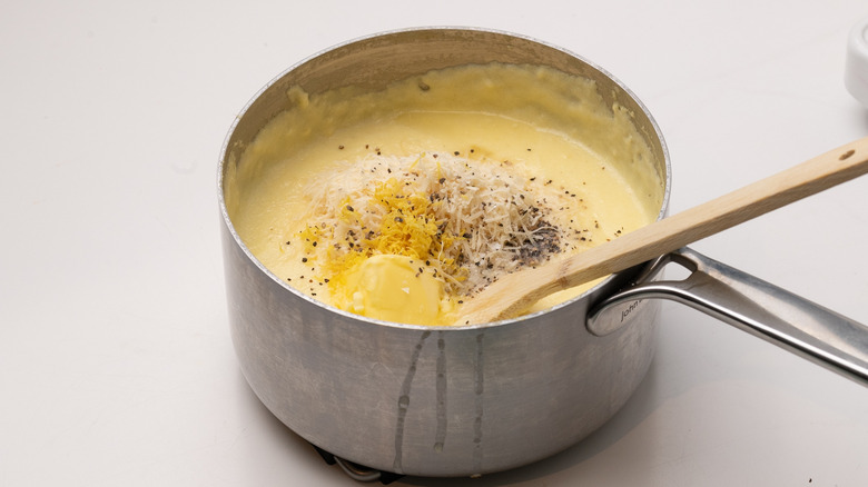 mixing butter and cheese into polenta