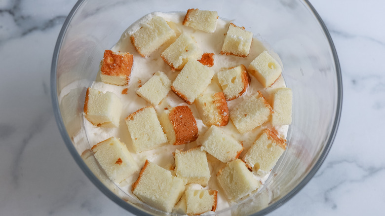 pound cake over whipped cream in a trifle dish