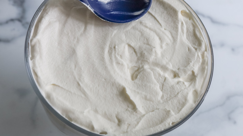 a trifle dish with whipped cream at the top