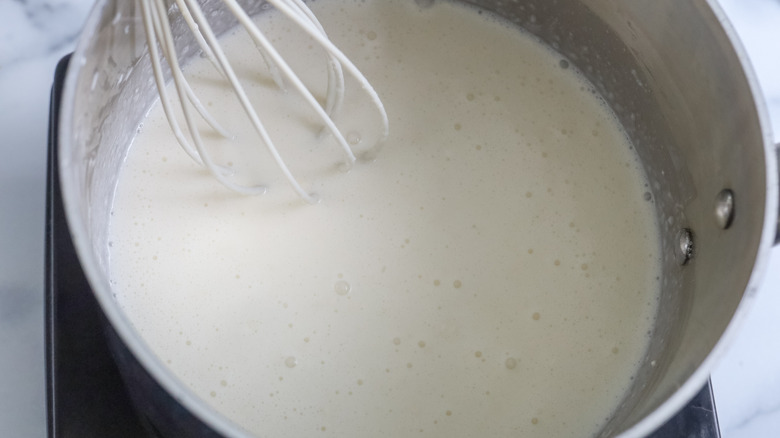 a saucepan filled with cream