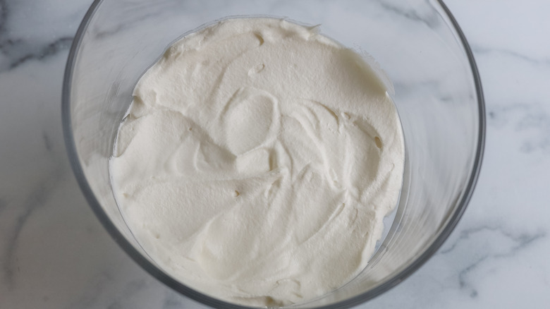 whipped cream spread on the bottom of a trifle dish