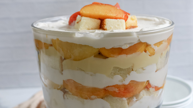 peaches and cream trifle in a dish on a table