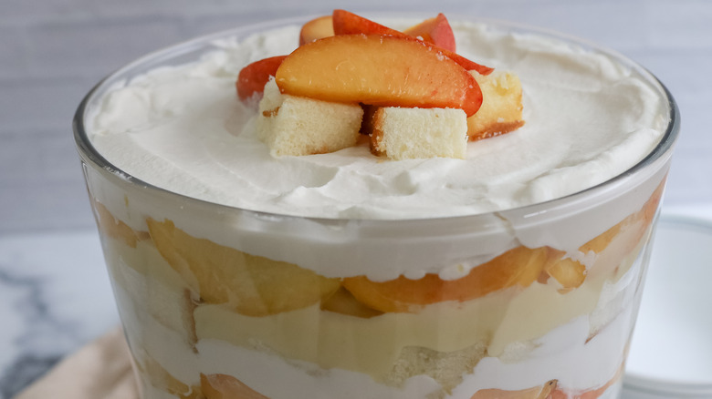 close up of a peaches and cream trifle in a dish