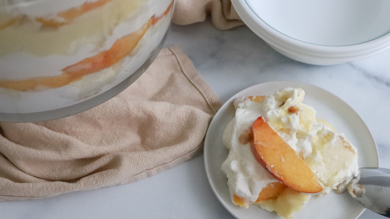 a plate of peaches and cream trifle on a table