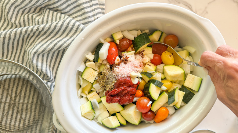 hand stirring slow cooker ingredients