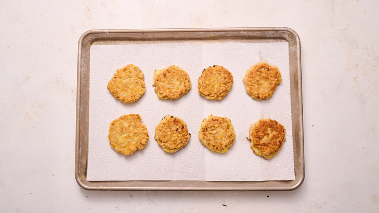 draining fritters on paper towel