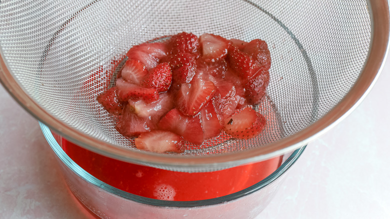 straining strawberry syrup