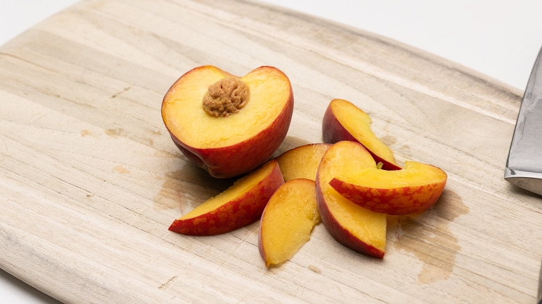 sliced peach on chopping board