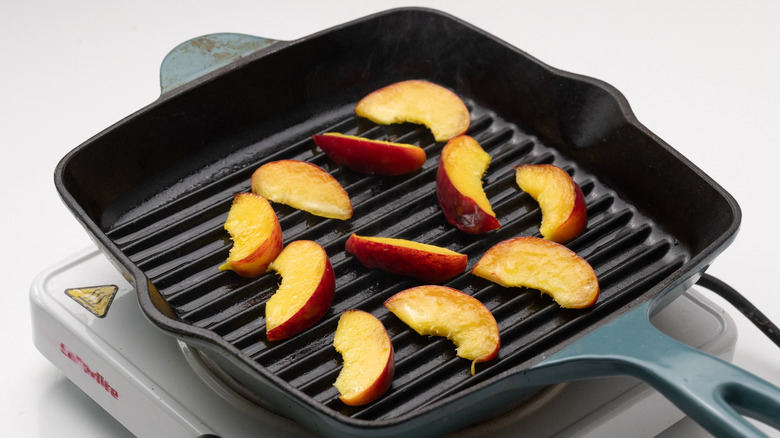 peach slices on griddle pan