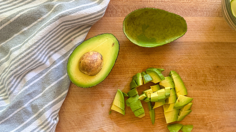 sliced avocado on board