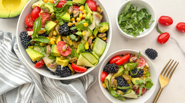 two salad bowls and basil