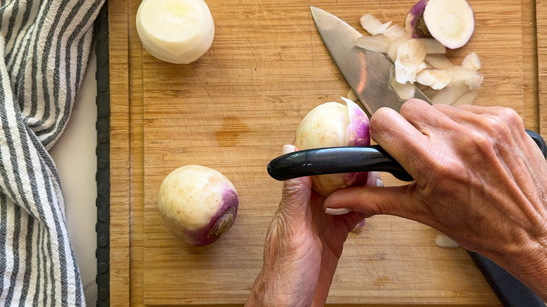 hands peeling turnip