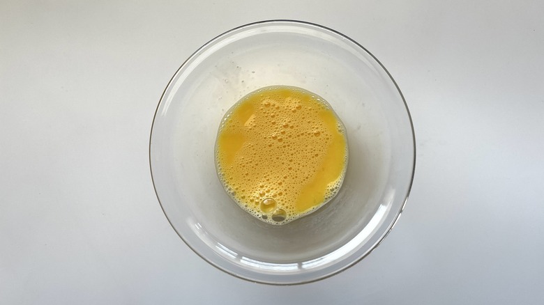 beaten egg in clear bowl