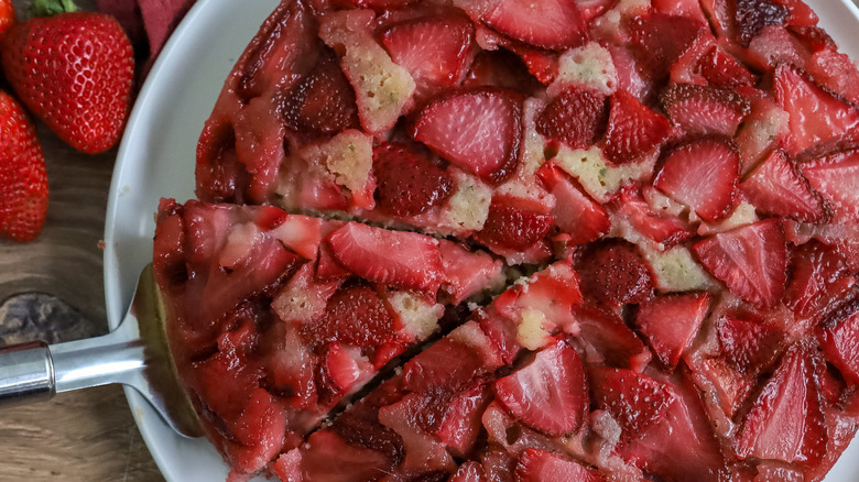 strawberry basil upside down cake being cut and served