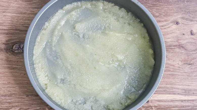 a round pan with butter and sugar in it