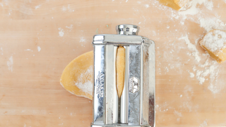 passing dough through pasta roller