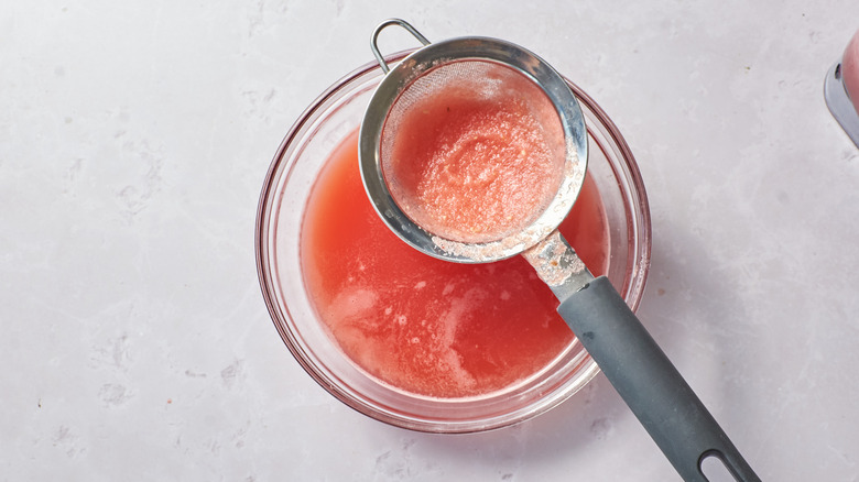 straining watermelon juice