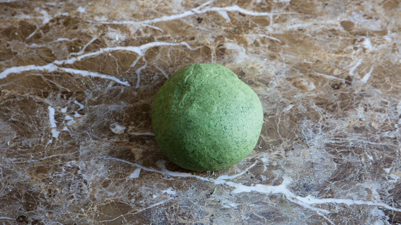 green dough ball on countertop