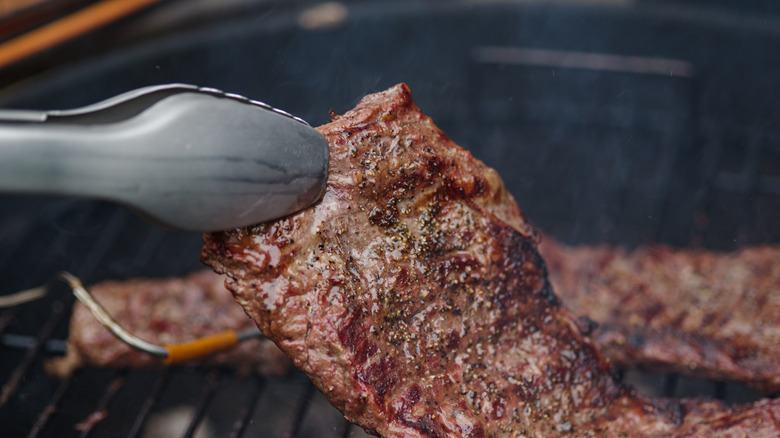 BBQ flank steak on a grill