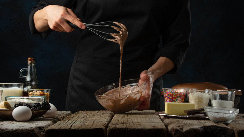 Chef mixing chocolate cake mix in a bowl