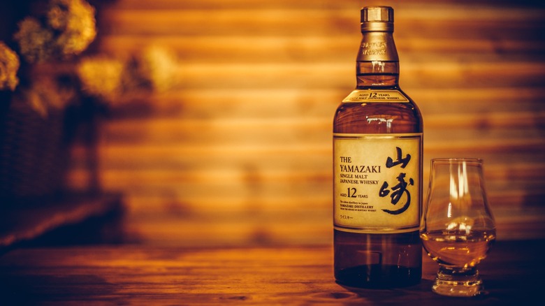 A bottle of Suntory Yamazaki 12 Whisky and glass